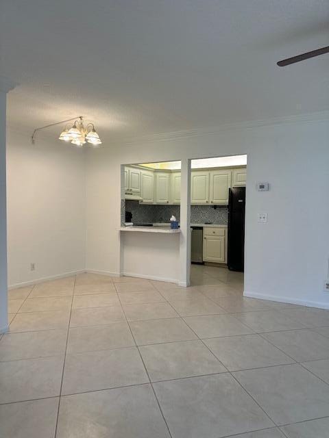3625 La Aires Ct Unit B-1, Greenacres, FL 33463 - interior space with ceiling fan with notable chandelier, light tile patterned flooring, and baseboards