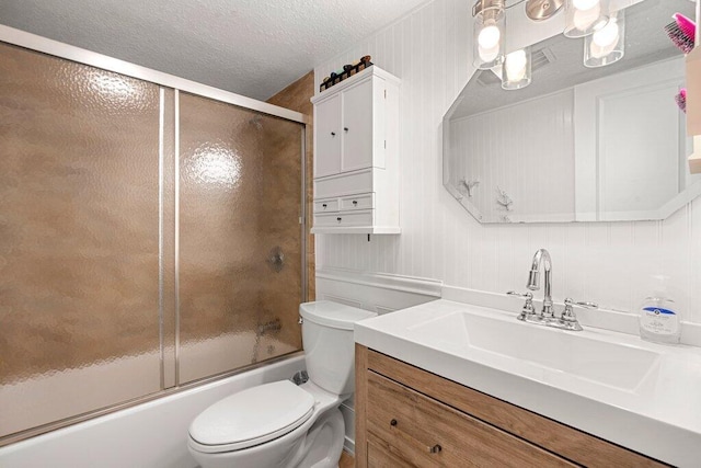 full bathroom featuring vanity, toilet, and combined bath / shower with glass door