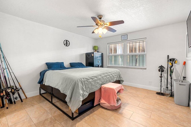 bedroom with ceiling fan and a textured ceiling