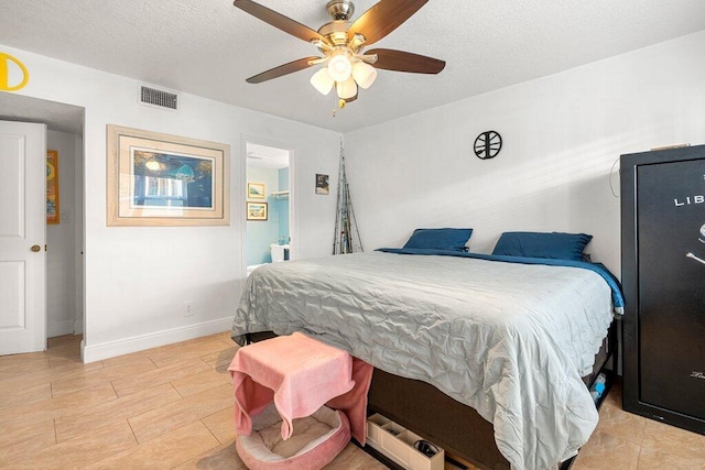 bedroom featuring ceiling fan, a textured ceiling, and connected bathroom