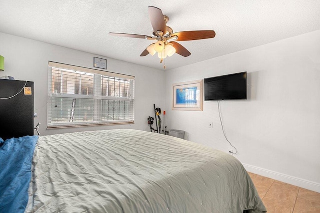 tiled bedroom with ceiling fan and a textured ceiling