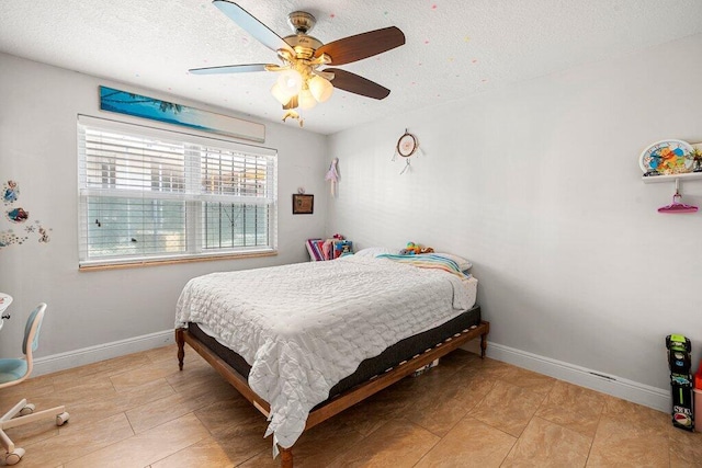 bedroom with a textured ceiling and ceiling fan