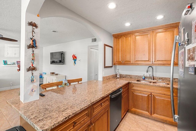 kitchen featuring sink, dishwasher, light stone countertops, kitchen peninsula, and a textured ceiling