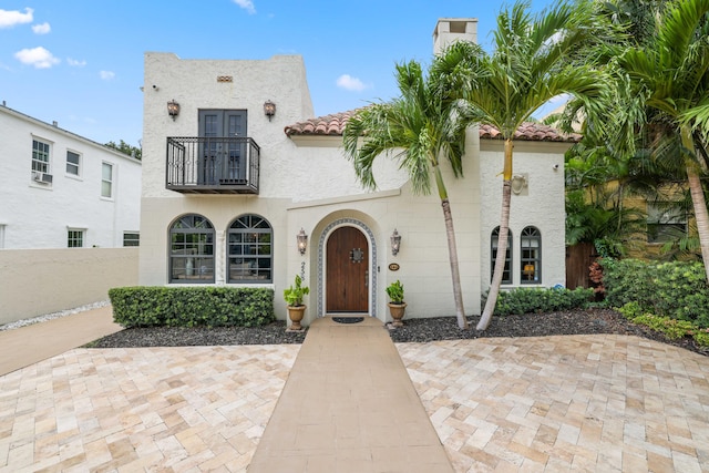 mediterranean / spanish-style home with a balcony