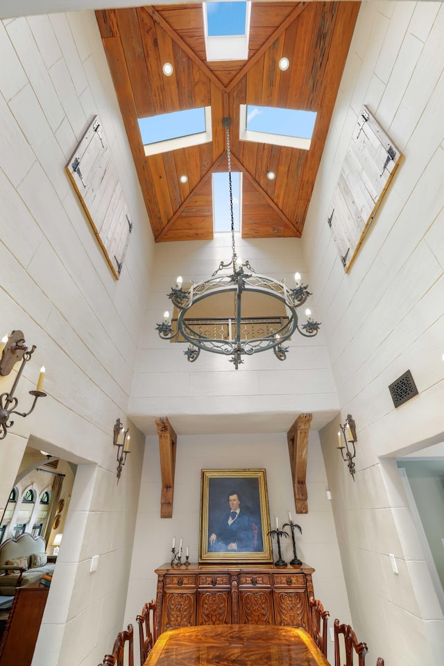 stairway featuring a skylight and high vaulted ceiling