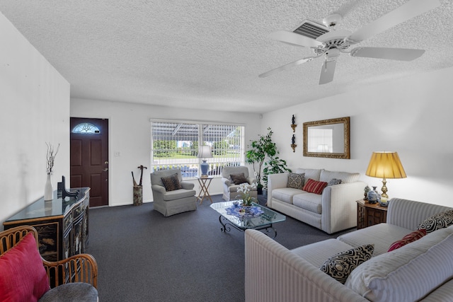 carpeted living room with ceiling fan and a textured ceiling