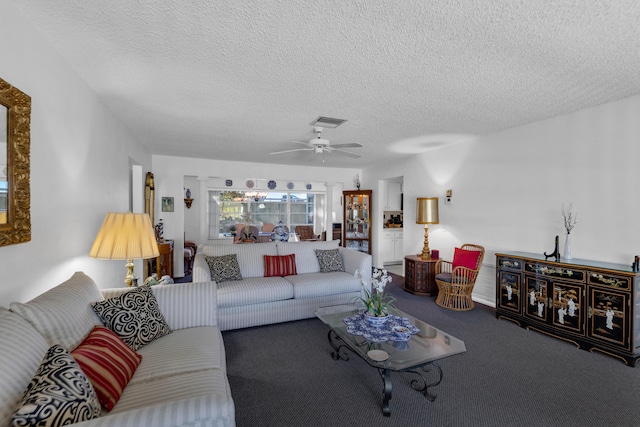 carpeted living room with ceiling fan and a textured ceiling