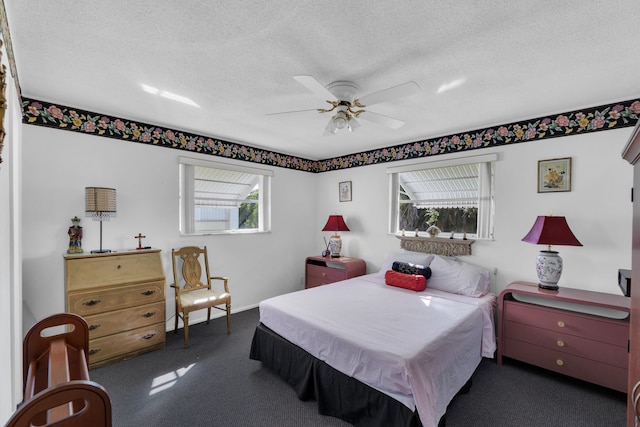 carpeted bedroom featuring ceiling fan and a textured ceiling