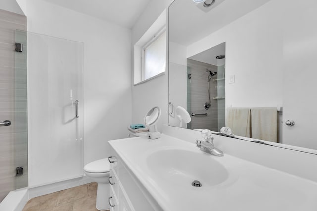 bathroom featuring walk in shower, vanity, toilet, and tile patterned floors