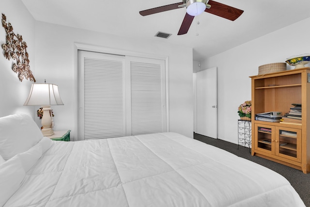 carpeted bedroom with ceiling fan and a closet