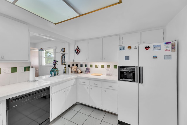 kitchen with decorative backsplash, black dishwasher, white fridge with ice dispenser, and white cabinetry