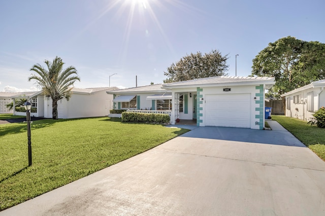 ranch-style house with a garage and a front lawn