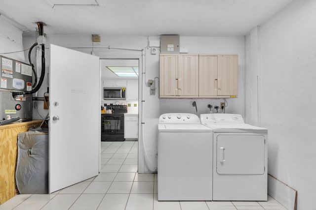 laundry area with heating unit, light tile patterned floors, washing machine and clothes dryer, and cabinets