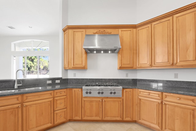 kitchen with stainless steel gas stovetop, dark stone countertops, sink, and ventilation hood