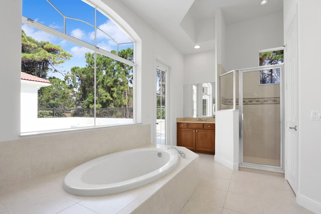 bathroom with vanity, plus walk in shower, and tile patterned flooring