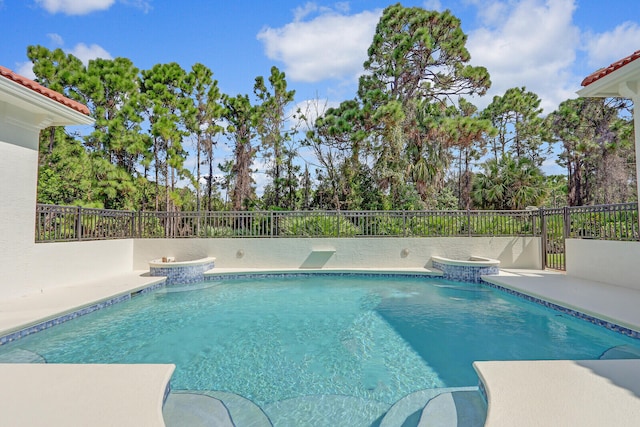 view of swimming pool with a jacuzzi