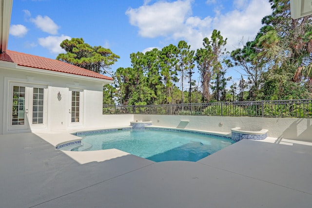 view of pool featuring a patio and french doors