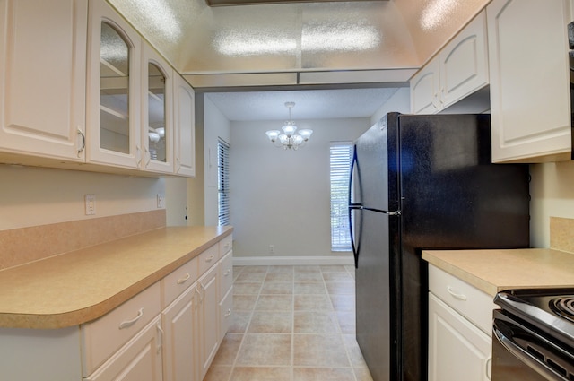 kitchen featuring pendant lighting, light tile patterned flooring, white cabinets, a chandelier, and stainless steel range