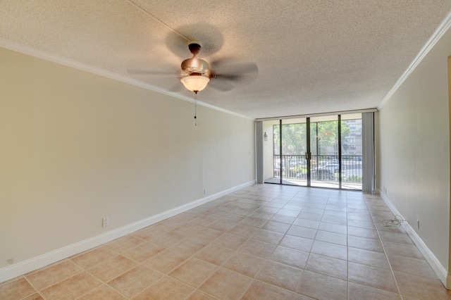 spare room featuring a textured ceiling, light tile patterned floors, crown molding, ceiling fan, and expansive windows