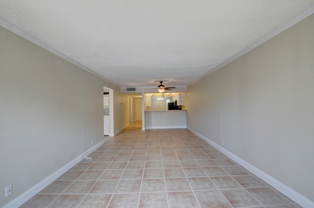 unfurnished room featuring a textured ceiling, ceiling fan, light tile patterned flooring, and crown molding