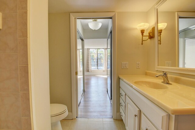 bathroom with vanity, hardwood / wood-style floors, and toilet