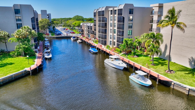 view of home's community with a lawn and a water view