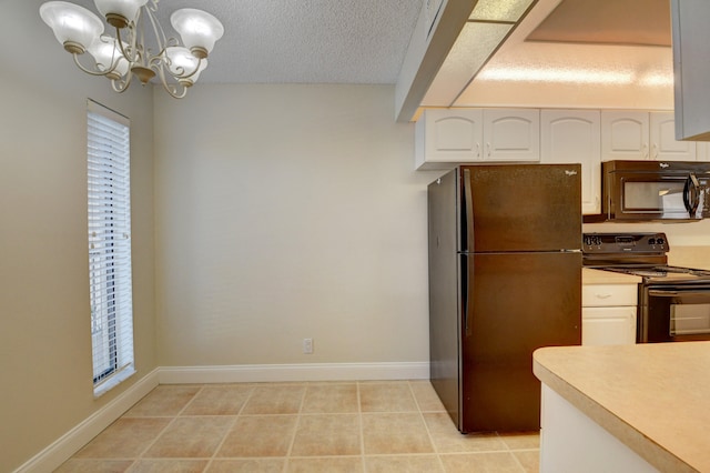 kitchen featuring black appliances, light tile patterned floors, white cabinetry, and a chandelier