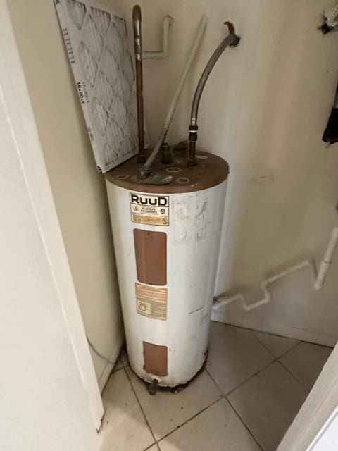 utility room featuring water heater