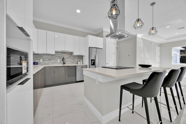 kitchen featuring hanging light fixtures, white cabinetry, a kitchen island, black appliances, and crown molding