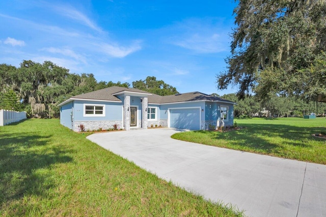 ranch-style home with a garage and a front lawn