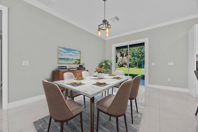 dining space featuring crown molding and an inviting chandelier