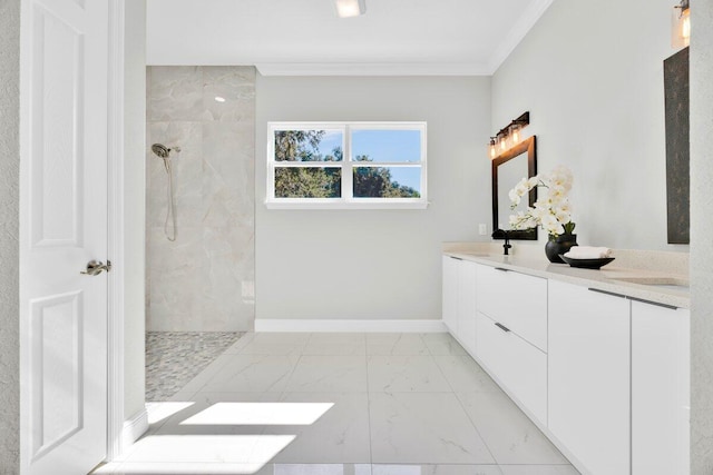 bathroom featuring ornamental molding, vanity, and tiled shower