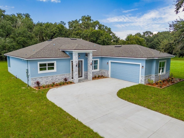 view of front of property with a front yard and a garage