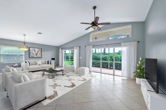 living room with ceiling fan, light tile patterned flooring, a healthy amount of sunlight, and vaulted ceiling