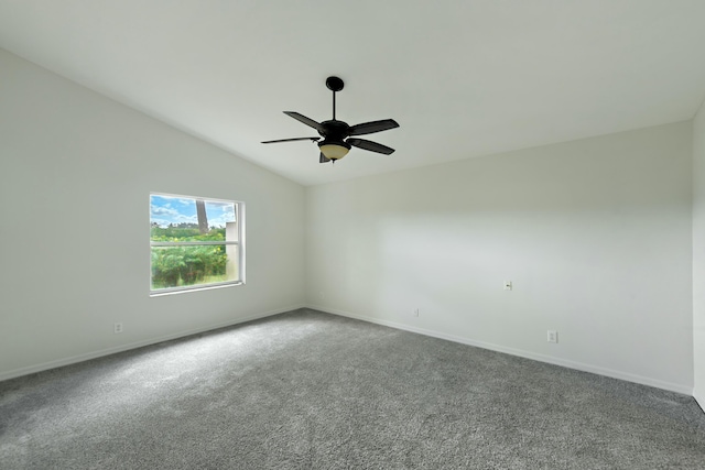 empty room featuring carpet floors, vaulted ceiling, and ceiling fan