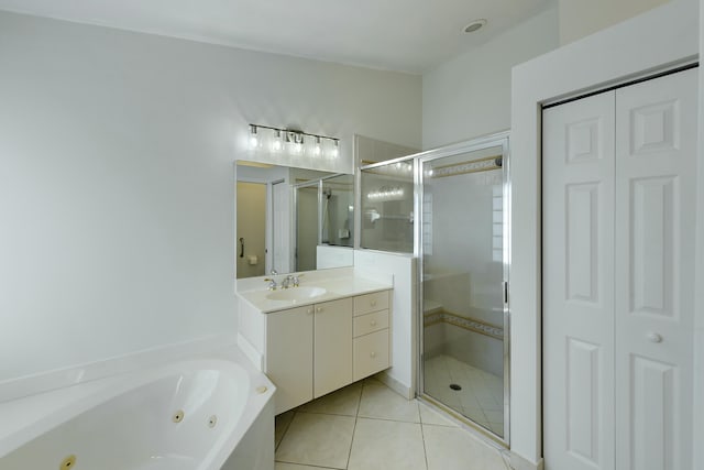 bathroom featuring tile patterned flooring, vanity, and shower with separate bathtub