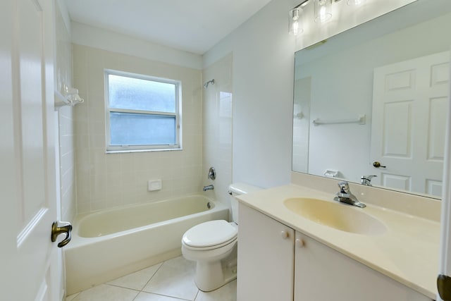 full bathroom featuring toilet, vanity, tiled shower / bath combo, and tile patterned floors