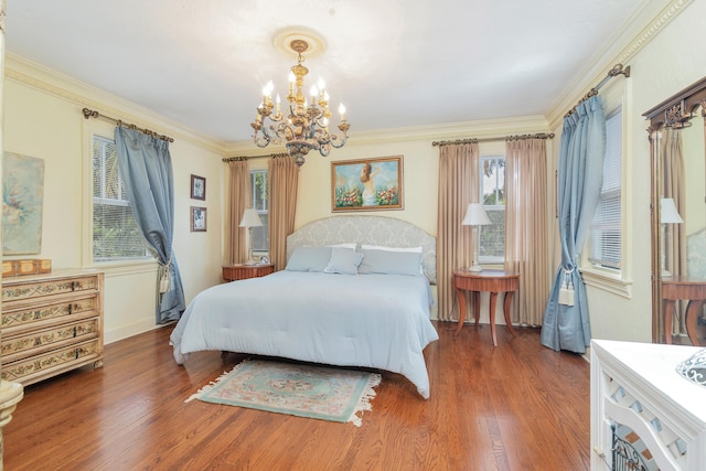 bedroom featuring ornamental molding, a chandelier, and dark wood-type flooring