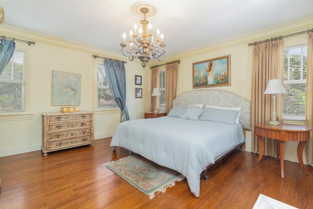 bedroom with crown molding, dark hardwood / wood-style flooring, and a notable chandelier