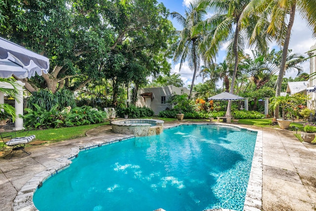 view of swimming pool featuring a patio and an in ground hot tub