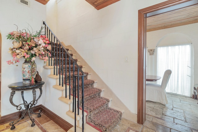 staircase featuring ornamental molding