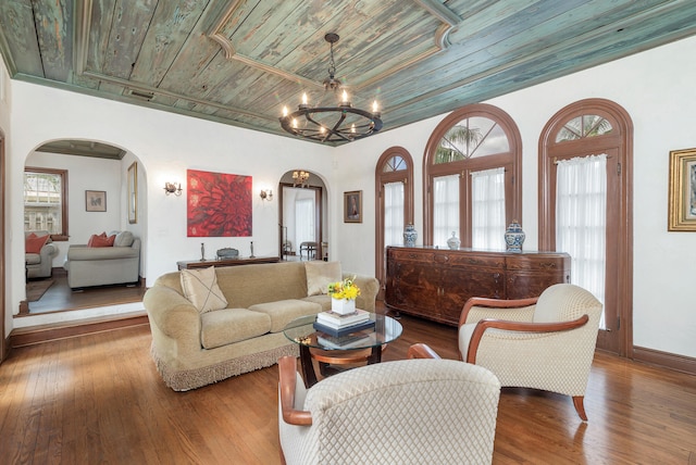 living room featuring hardwood / wood-style flooring, wood ceiling, and a notable chandelier