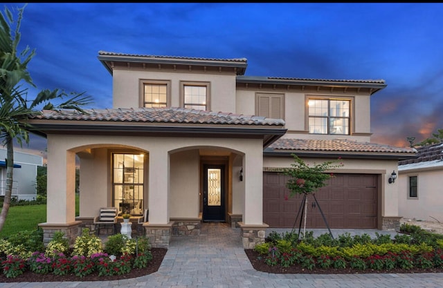 mediterranean / spanish home featuring a garage