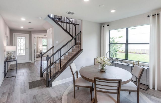 dining space with light wood-type flooring and a wealth of natural light