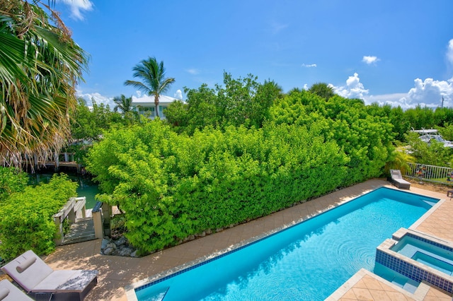 view of pool featuring an in ground hot tub