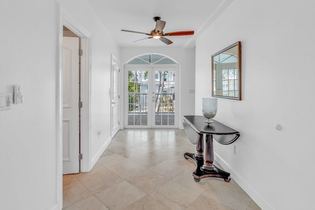 foyer entrance featuring ceiling fan and french doors