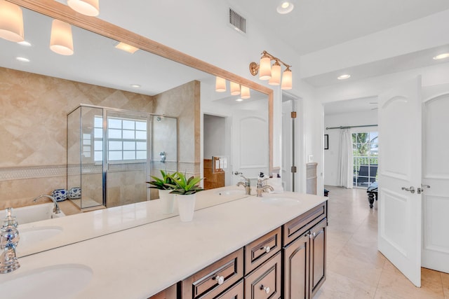 bathroom with independent shower and bath, vanity, tile walls, and tile patterned floors