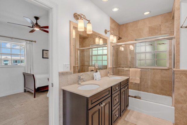 bathroom featuring tile walls, combined bath / shower with glass door, tile patterned floors, ceiling fan, and vanity