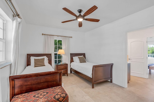 bedroom with multiple windows and ceiling fan