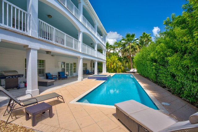 view of pool featuring a patio, an outdoor living space, an in ground hot tub, and a grill